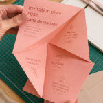 Carte d'invitation pliée rose élégante pour événement festif.